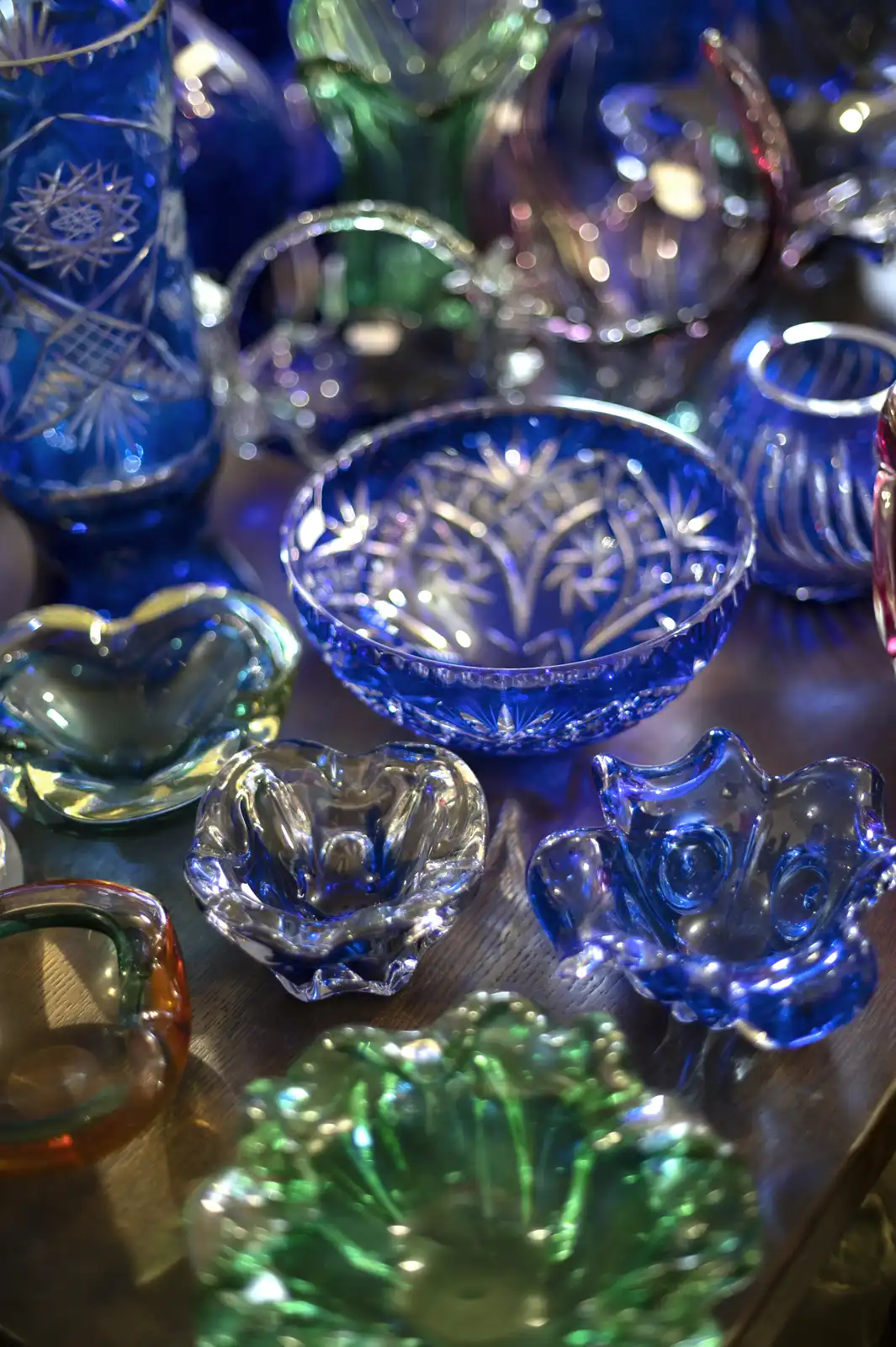 Blue and green vintage pressed glass dishes with molded patterns at an antique store